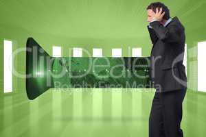 Composite image of stressed businessman with hands on head