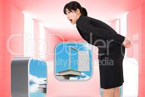 Composite image of surprised businesswoman bending