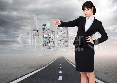 Composite image of focused businesswoman pointing