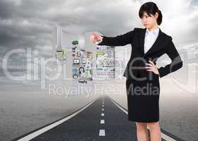 Composite image of focused businesswoman pointing