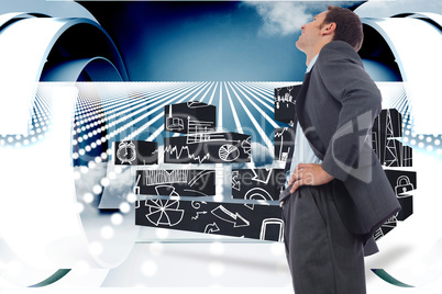 Composite image of cheerful businessman standing with hands on h