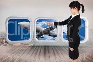 Composite image of focused businesswoman pointing