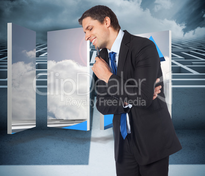 Composite image of thinking businessman holding pen