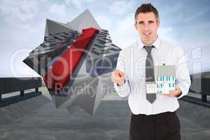 Composite image of businessman holding a key and a miniature hou