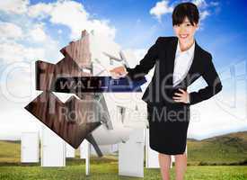 Composite image of smiling businesswoman pointing