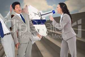 Composite image of businesswoman with megaphone yelling at colle
