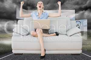 Composite image of cheering beautiful businesswoman sitting on c