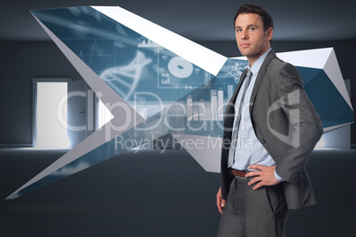 Composite image of serious businessman with hand on hip