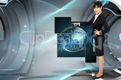 Composite image of focused businesswoman pointing