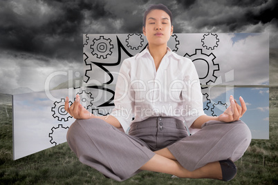 Composite image of businesswoman sitting in lotus pose