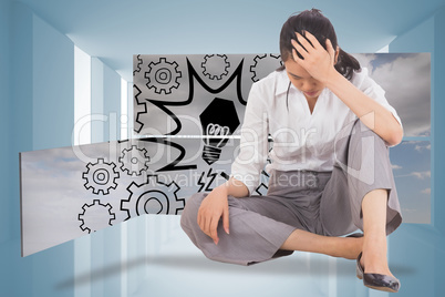 Composite image of depressed businesswoman sitting with hand on