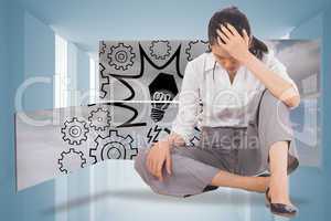 Composite image of depressed businesswoman sitting with hand on