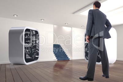 Composite image of businessman standing with hand on hip