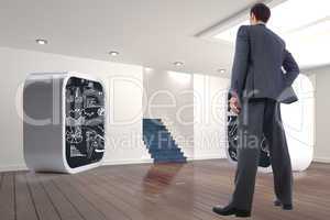 Composite image of businessman standing with hand on hip