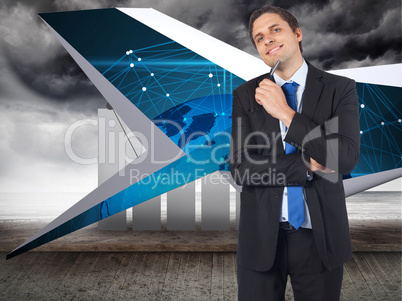 Composite image of thinking businessman holding pen