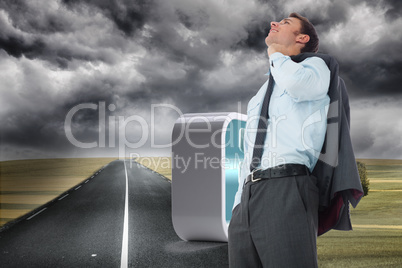 Composite image of smiling businessman holding his jacket