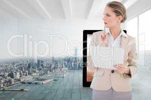 Composite image of pensive blonde businesswoman holding clipboar