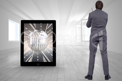 Composite image of thoughtful businessman holding pen