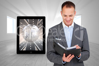 Composite image of arttractive businessman consulting his agenda