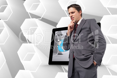 Composite image of thoughtful businessman with hand on chin