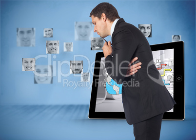 Composite image of thinking businessman holding pen