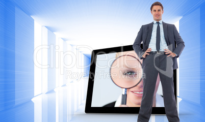 Composite image of happy businessman with hands on hips