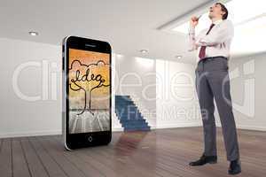 Composite image of thinking businessman holding pen