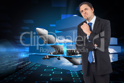 Composite image of thinking businessman holding pen