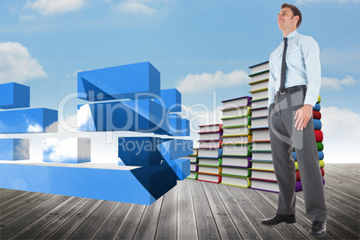 Composite image of happy businessman standing with hands in pock