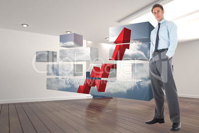 Composite image of serious businessman standing with hands in po