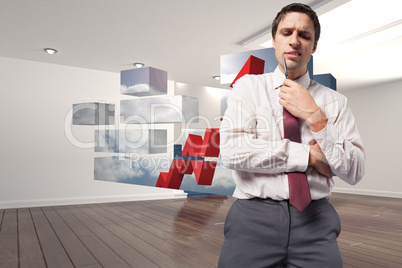 Composite image of thoughtful businessman holding pen to chin