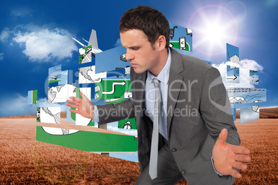 Composite image of businessman posing with hands out