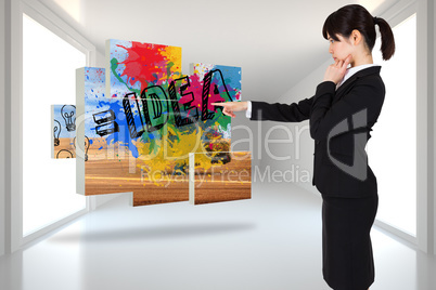 Composite image of thoughtful businesswoman pointing