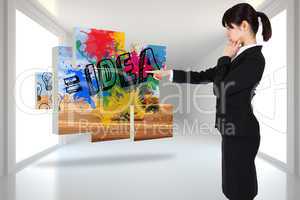 Composite image of thoughtful businesswoman pointing