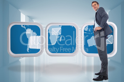 Composite image of happy businessman with hands on hips