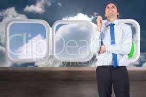 Composite image of thinking businessman holding pen