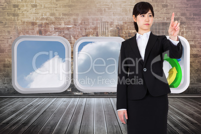 Composite image of focused businesswoman pointing