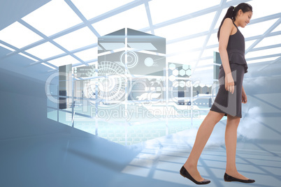 Composite image of asian businesswoman walking