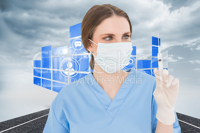 Composite image of pretty brunette female doctor holding a syrin