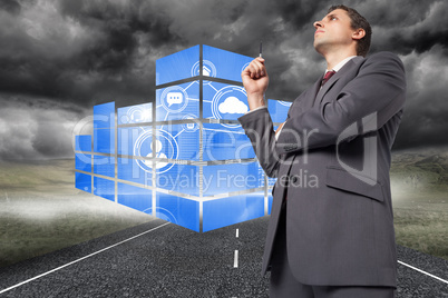 Composite image of thoughtful businessman holding pen