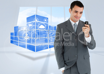 Composite image of smiling businessman looking at his cellphone