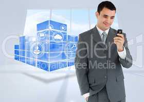 Composite image of smiling businessman looking at his cellphone