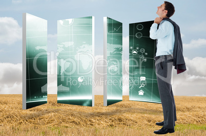 Composite image of smiling businessman holding his jacket