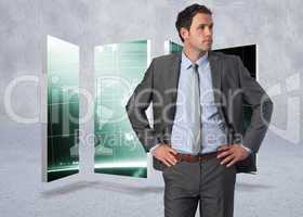 Composite image of serious businessman with hands on hips