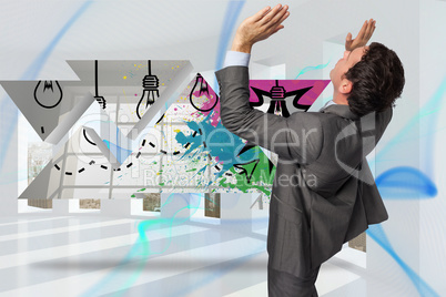 Composite image of businessman standing with arms pressing up