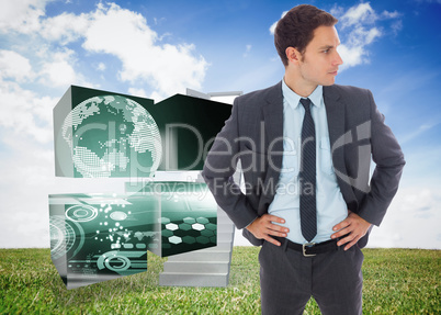 Composite image of serious businessman standing with hands on hi