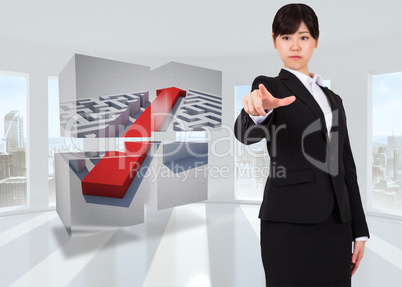 Composite image of focused businesswoman pointing