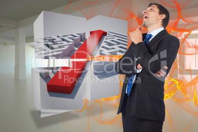 Composite image of thinking businessman holding pen