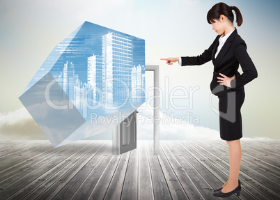 Composite image of focused businesswoman pointing