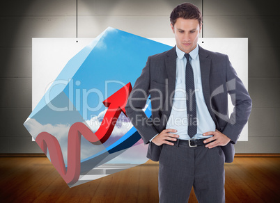 Composite image of serious businessman with hands on hips